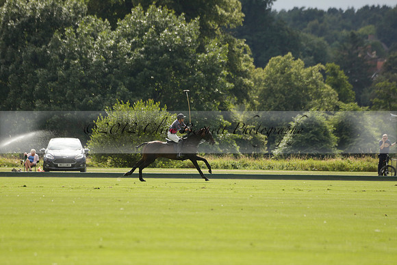 La Tremenda (lilac) v Maiz Dulce (yellow) in a Brecknock Cup polo match played on Lawns 1 at the Cowdray Park Polo Club on Tuesday 13 August 2013