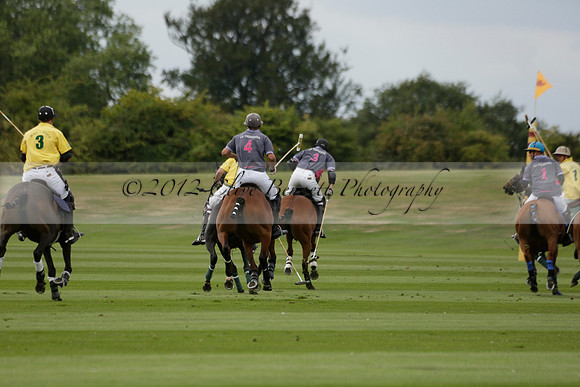 La Tremenda (lilac) v Maiz Dulce (yellow) in a Brecknock Cup polo match played on Lawns 1 at the Cowdray Park Polo Club on Tuesday 13 August 2013
