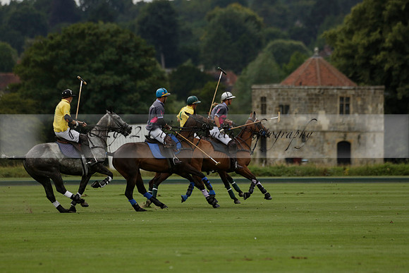 La Tremenda (lilac) v Maiz Dulce (yellow) in a Brecknock Cup polo match played on Lawns 1 at the Cowdray Park Polo Club on Tuesday 13 August 2013