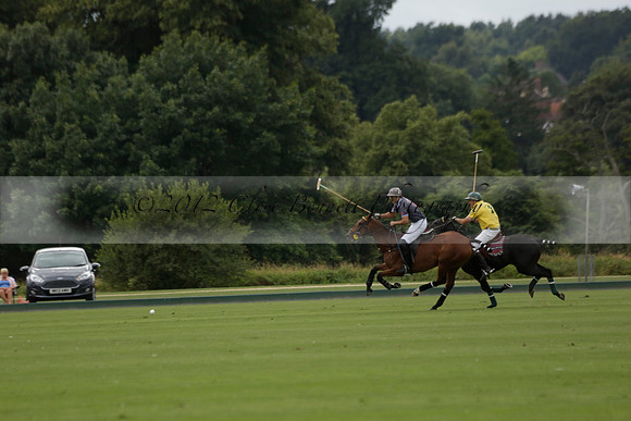 La Tremenda (lilac) v Maiz Dulce (yellow) in a Brecknock Cup polo match played on Lawns 1 at the Cowdray Park Polo Club on Tuesday 13 August 2013