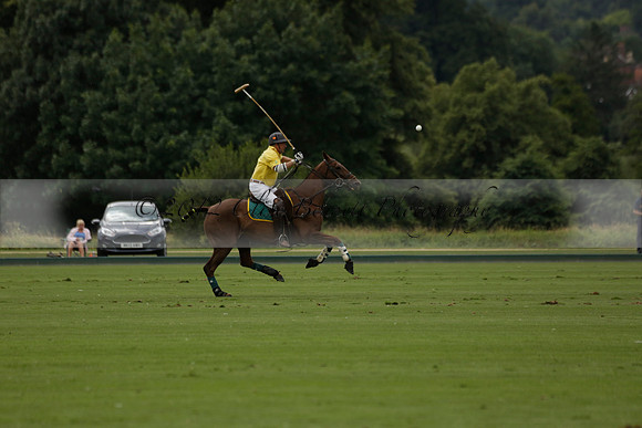 La Tremenda (lilac) v Maiz Dulce (yellow) in a Brecknock Cup polo match played on Lawns 1 at the Cowdray Park Polo Club on Tuesday 13 August 2013