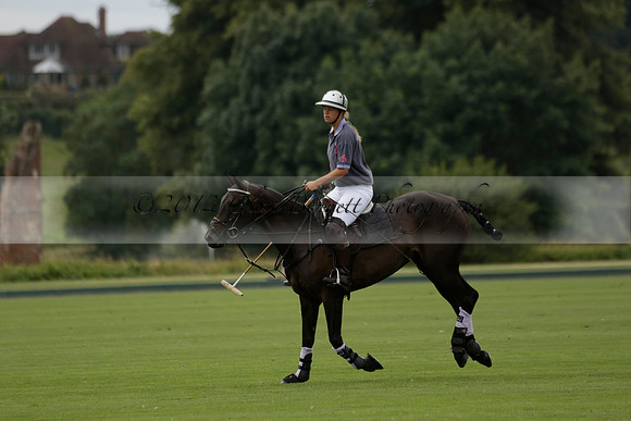 La Tremenda (lilac) v Maiz Dulce (yellow) in a Brecknock Cup polo match played on Lawns 1 at the Cowdray Park Polo Club on Tuesday 13 August 2013