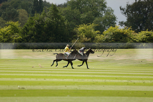 La Tremenda (lilac) v Maiz Dulce (yellow) in a Brecknock Cup polo match played on Lawns 1 at the Cowdray Park Polo Club on Tuesday 13 August 2013