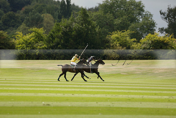 La Tremenda (lilac) v Maiz Dulce (yellow) in a Brecknock Cup polo match played on Lawns 1 at the Cowdray Park Polo Club on Tuesday 13 August 2013