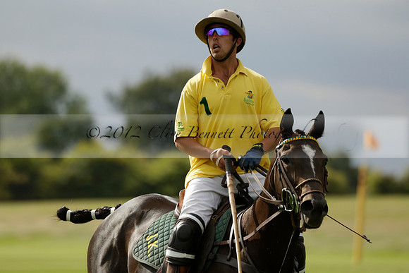 La Tremenda (lilac) v Maiz Dulce (yellow) in a Brecknock Cup polo match played on Lawns 1 at the Cowdray Park Polo Club on Tuesday 13 August 2013