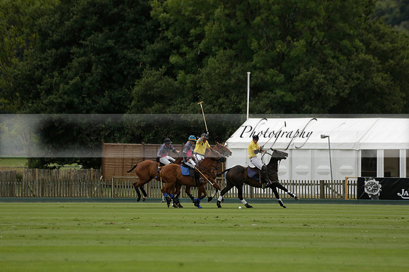 La Tremenda (lilac) v Maiz Dulce (yellow) in a Brecknock Cup polo match played on Lawns 1 at the Cowdray Park Polo Club on Tuesday 13 August 2013