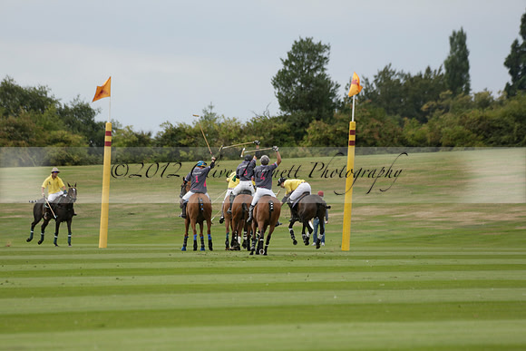 La Tremenda (lilac) v Maiz Dulce (yellow) in a Brecknock Cup polo match played on Lawns 1 at the Cowdray Park Polo Club on Tuesday 13 August 2013