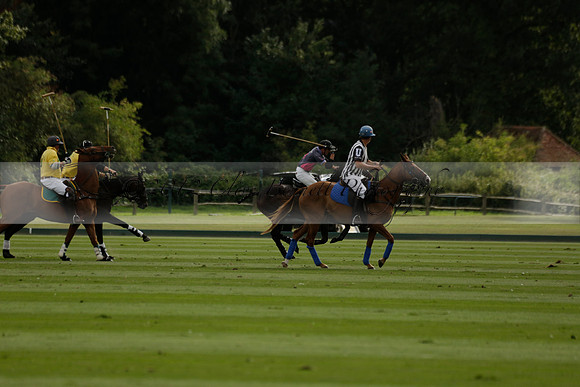 La Tremenda (lilac) v Maiz Dulce (yellow) in a Brecknock Cup polo match played on Lawns 1 at the Cowdray Park Polo Club on Tuesday 13 August 2013