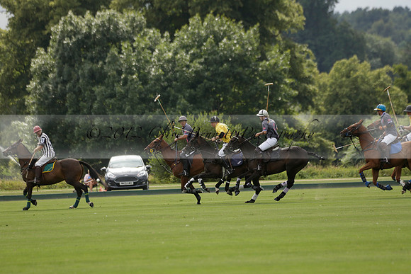 La Tremenda (lilac) v Maiz Dulce (yellow) in a Brecknock Cup polo match played on Lawns 1 at the Cowdray Park Polo Club on Tuesday 13 August 2013