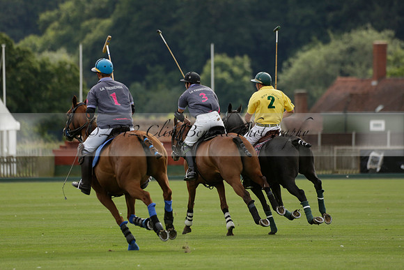 La Tremenda (lilac) v Maiz Dulce (yellow) in a Brecknock Cup polo match played on Lawns 1 at the Cowdray Park Polo Club on Tuesday 13 August 2013
