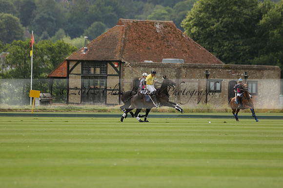 La Tremenda (lilac) v Maiz Dulce (yellow) in a Brecknock Cup polo match played on Lawns 1 at the Cowdray Park Polo Club on Tuesday 13 August 2013