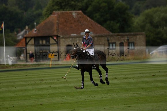 La Tremenda (lilac) v Maiz Dulce (yellow) in a Brecknock Cup polo match played on Lawns 1 at the Cowdray Park Polo Club on Tuesday 13 August 2013