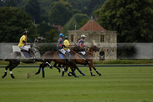 La Tremenda (lilac) v Maiz Dulce (yellow) in a Brecknock Cup polo match played on Lawns 1 at the Cowdray Park Polo Club on Tuesday 13 August 2013