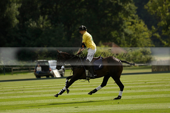 La Tremenda (lilac) v Maiz Dulce (yellow) in a Brecknock Cup polo match played on Lawns 1 at the Cowdray Park Polo Club on Tuesday 13 August 2013