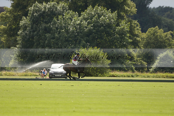La Tremenda (lilac) v Maiz Dulce (yellow) in a Brecknock Cup polo match played on Lawns 1 at the Cowdray Park Polo Club on Tuesday 13 August 2013