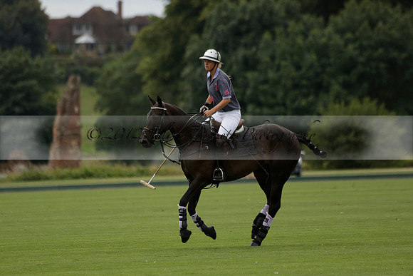 La Tremenda (lilac) v Maiz Dulce (yellow) in a Brecknock Cup polo match played on Lawns 1 at the Cowdray Park Polo Club on Tuesday 13 August 2013