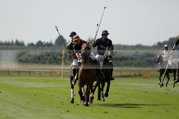 Maiz Dulce (green) v River (blue) in a Uber Polo Midsummer 12 goal polo match on Wednesday 21 August 2013 at Cowdray park Polo Club on Ambersham 2.  www.polopictures.co.uk