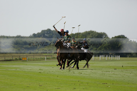 Maiz Dulce (green) v River (blue) in a Uber Polo Midsummer 12 goal polo match on Wednesday 21 August 2013 at Cowdray park Polo Club on Ambersham 2.  www.polopictures.co.uk