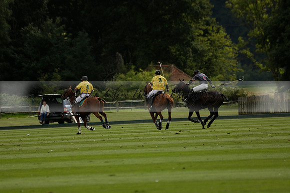 La Tremenda (lilac) v Maiz Dulce (yellow) in a Brecknock Cup polo match played on Lawns 1 at the Cowdray Park Polo Club on Tuesday 13 August 2013