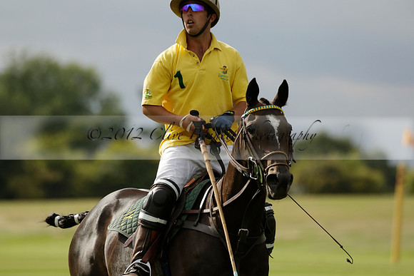 La Tremenda (lilac) v Maiz Dulce (yellow) in a Brecknock Cup polo match played on Lawns 1 at the Cowdray Park Polo Club on Tuesday 13 August 2013