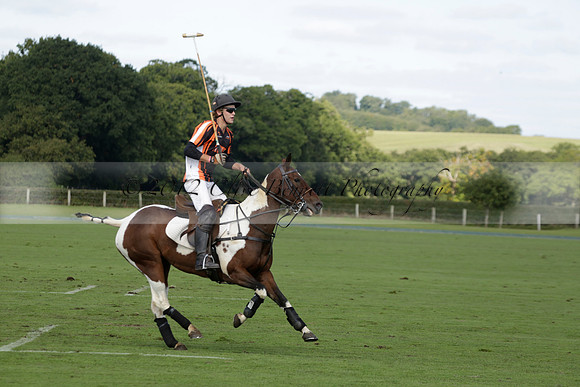 Four Quarters Black (black) v BHC (red) in a Autumn Cup polo match on Ambersham 2 at Cowdray Park Polo Club on Friday 20 September 2013 www.polopictures.co.uk
