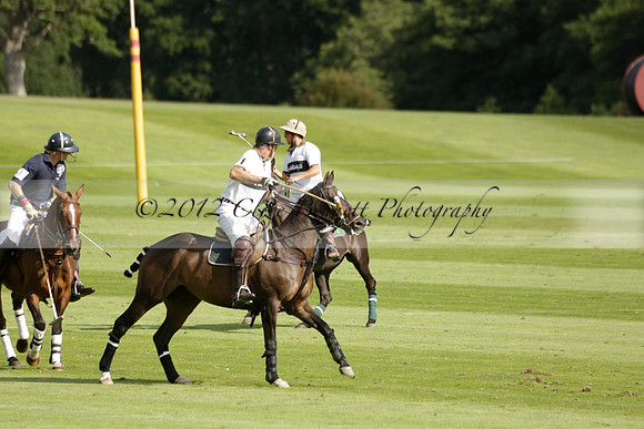Pandas (white) v Home Farm (navy) in a Park House West Sussex Cup Polo match on Brooksfield at Cowdray Park Polo Club on Friday 30 August 2013. 2013.08.30 www.polopictures.co.uk