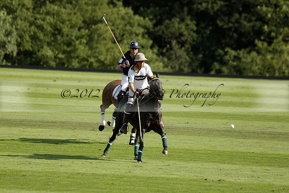 Pandas (white) v Home Farm (navy) in a Park House West Sussex Cup Polo match on Brooksfield at Cowdray Park Polo Club on Friday 30 August 2013. 2013.08.30 www.polopictures.co.uk