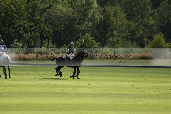 Pandas (white) v Home Farm (navy) in a Park House West Sussex Cup Polo match on Brooksfield at Cowdray Park Polo Club on Friday 30 August 2013. 2013.08.30 www.polopictures.co.uk