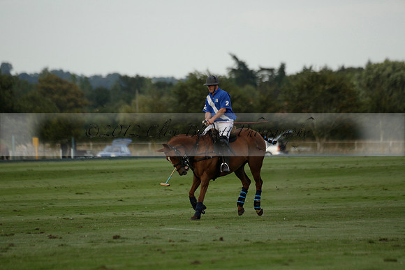 Ghost Chilli (blue) v Team Tonic (red) in a Lodsworth Cup Polo match on Ambersham 3 at Cowdray Park Polo Club on Friday 30 August 2013. 2013.08.30 www.polopictures.co.uk