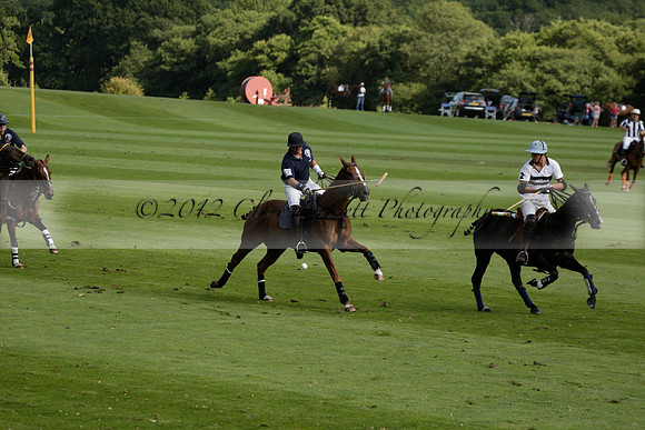 Pandas (white) v Home Farm (navy) in a Park House West Sussex Cup Polo match on Brooksfield at Cowdray Park Polo Club on Friday 30 August 2013. 2013.08.30 www.polopictures.co.uk