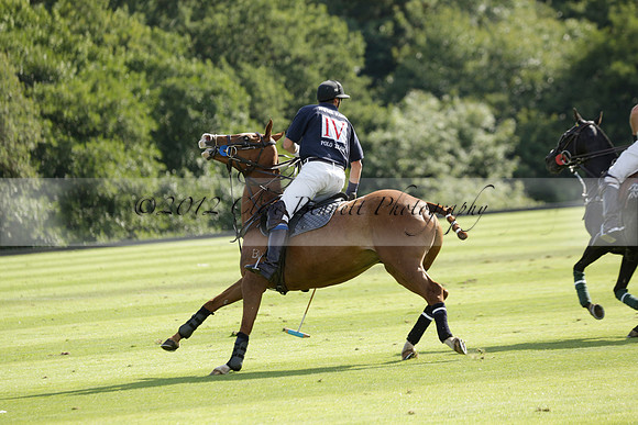 Pandas (white) v Home Farm (navy) in a Park House West Sussex Cup Polo match on Brooksfield at Cowdray Park Polo Club on Friday 30 August 2013. 2013.08.30 www.polopictures.co.uk