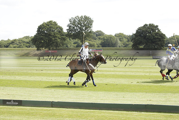 Combe Place (blue) v Silver Fox (white) in a Park House West Sussex Cup Polo match on Ambersham 1 at Cowdray Park Polo Club on Friday 30 August 2013. 2013.08.30 www.polopictures.co.uk