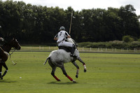 Combe Place (blue) v Silver Fox (white) in a Park House West Sussex Cup Polo match on Ambersham 1 at Cowdray Park Polo Club on Friday 30 August 2013. 2013.08.30 www.polopictures.co.uk
