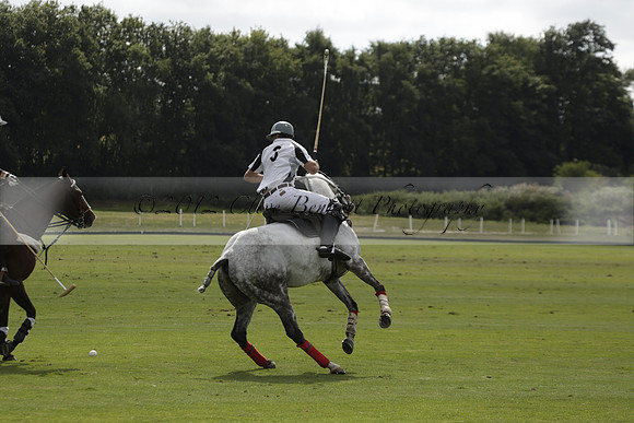 Combe Place (blue) v Silver Fox (white) in a Park House West Sussex Cup Polo match on Ambersham 1 at Cowdray Park Polo Club on Friday 30 August 2013. 2013.08.30 www.polopictures.co.uk