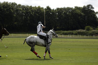 Combe Place (blue) v Silver Fox (white) in a Park House West Sussex Cup Polo match on Ambersham 1 at Cowdray Park Polo Club on Friday 30 August 2013. 2013.08.30 www.polopictures.co.uk