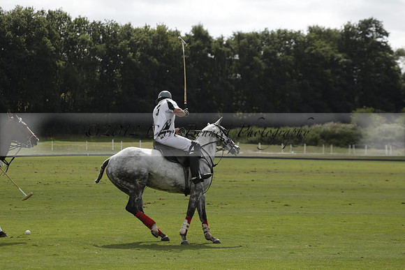Combe Place (blue) v Silver Fox (white) in a Park House West Sussex Cup Polo match on Ambersham 1 at Cowdray Park Polo Club on Friday 30 August 2013. 2013.08.30 www.polopictures.co.uk