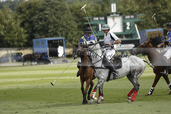 Combe Place (blue) v Silver Fox (white) in a Park House West Sussex Cup Polo match on Ambersham 1 at Cowdray Park Polo Club on Friday 30 August 2013. 2013.08.30 www.polopictures.co.uk