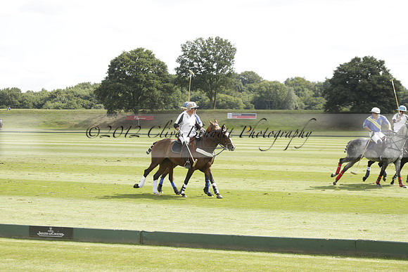 Combe Place (blue) v Silver Fox (white) in a Park House West Sussex Cup Polo match on Ambersham 1 at Cowdray Park Polo Club on Friday 30 August 2013. 2013.08.30 www.polopictures.co.uk