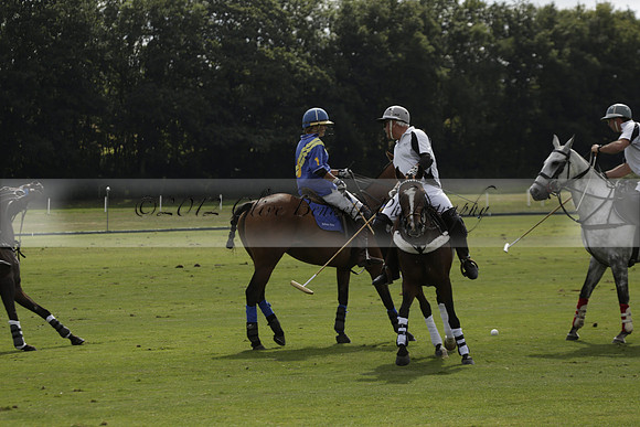 Combe Place (blue) v Silver Fox (white) in a Park House West Sussex Cup Polo match on Ambersham 1 at Cowdray Park Polo Club on Friday 30 August 2013. 2013.08.30 www.polopictures.co.uk
